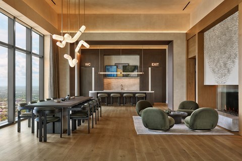 A modern dining room with a long table and chairs.