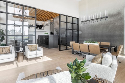 A modern living room with a white sofa set and a black cabinet.