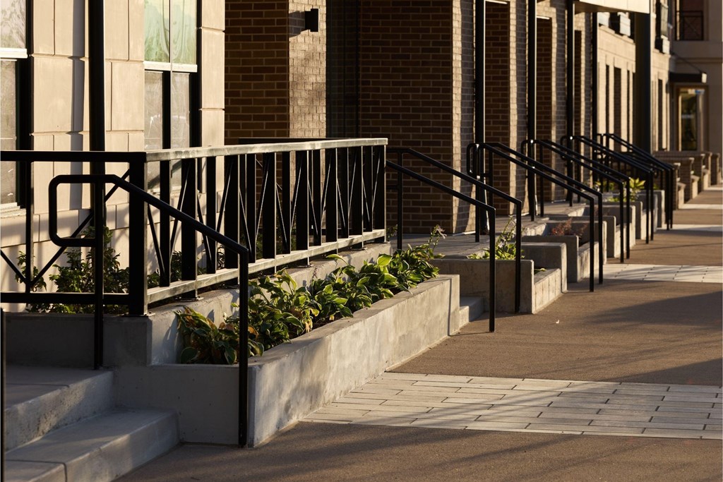 A black metal railing on a concrete staircase.