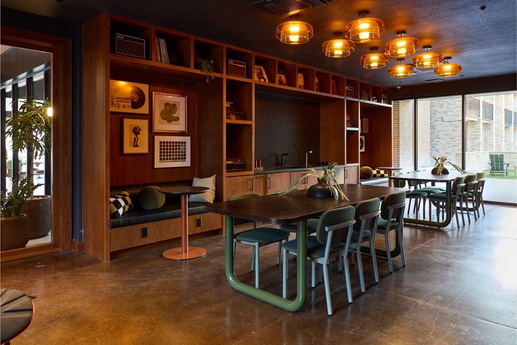 A room with a long table and chairs.