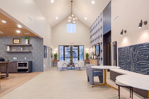 A residential lounge area with tables and chairs at The Wheeler townhomes near Salt Lake City, UT.