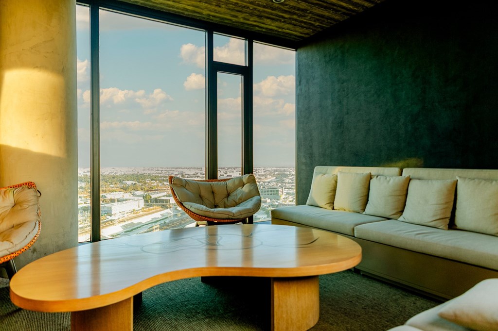 A modern living room with a large window overlooking the city.