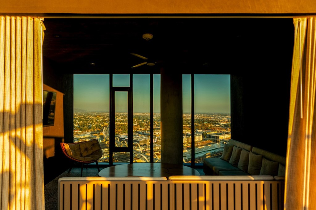 A room with a view of the cityscape from a high-rise building.