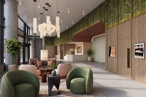 A modern living room with green chairs and a large chandelier.