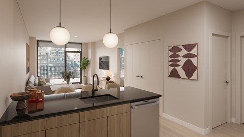 A modern kitchen with a large island and pendant lights.