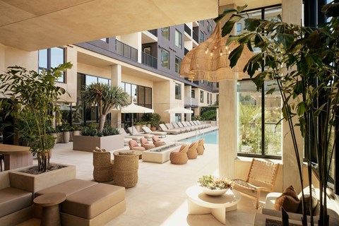A modern outdoor living space with wicker furniture and plants.