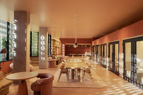 A modern dining room with a long table and chairs.