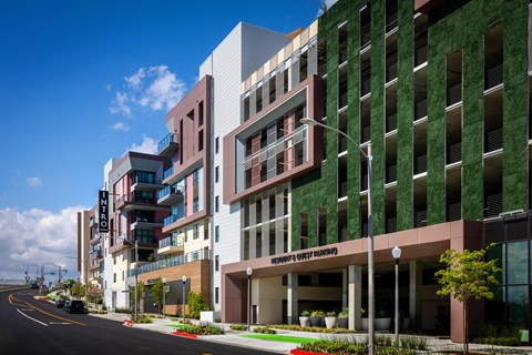 A modern building with a green wall on the side.