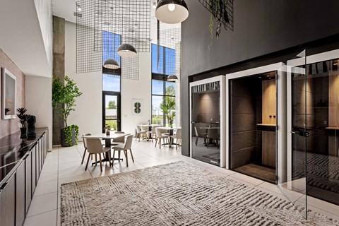 A modern kitchen with a dining table and chairs.