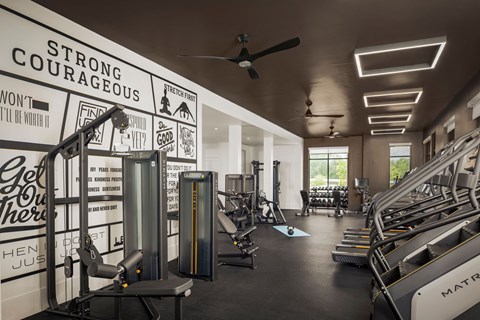 A gym with a wall of inspirational quotes.