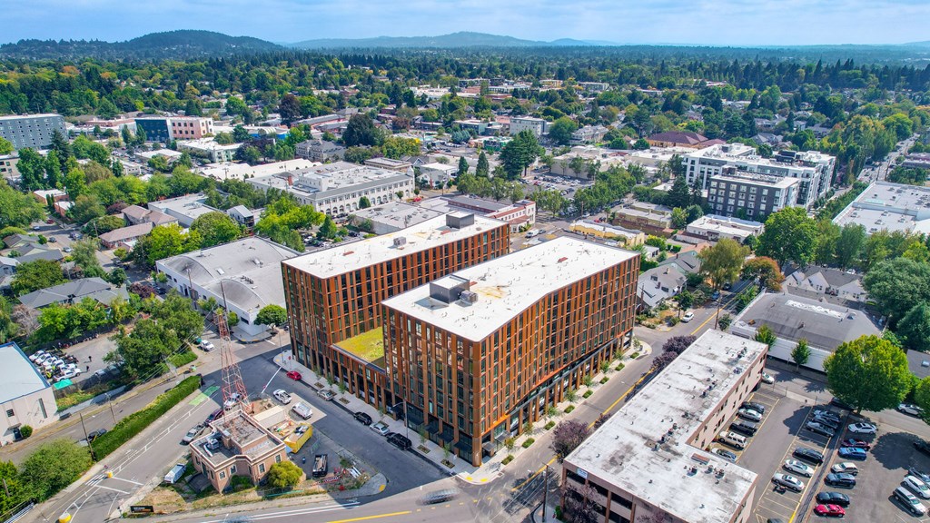 A large building surrounded by other buildings and trees.