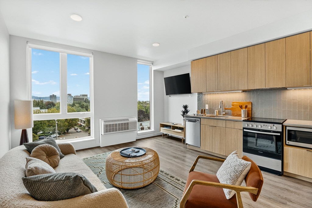 A modern living room with a large window overlooking the city.