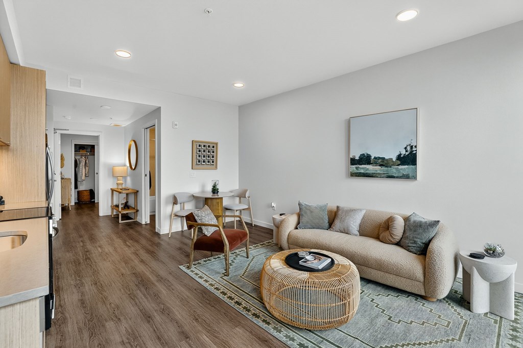 A living room with a couch, a chair, and a coffee table.