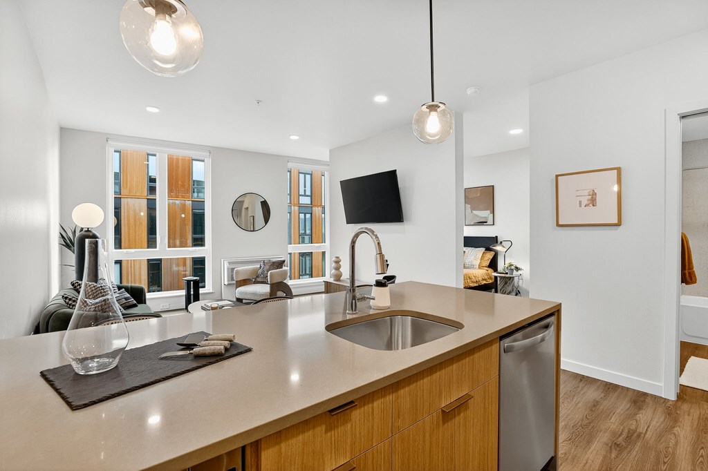 A modern kitchen with a wooden countertop and stainless steel appliances.