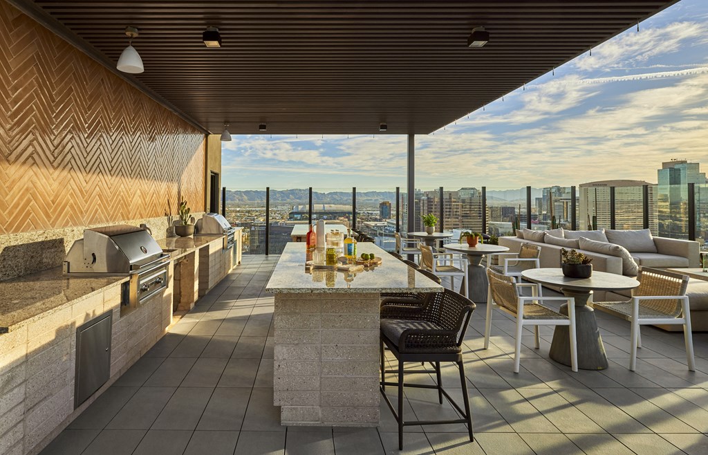 a rooftop lounge seating with a view of the city and skyscrapers