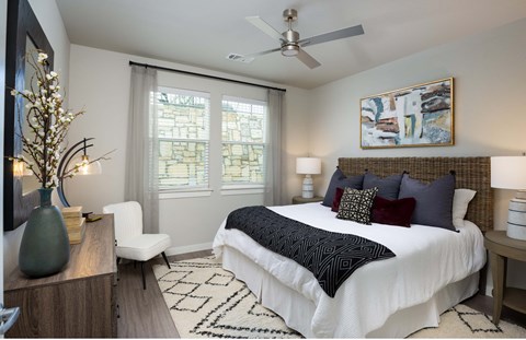 a bedroom with a large bed and a ceiling fan