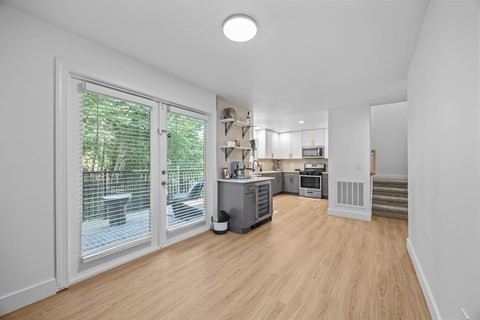 A kitchen area with a dining table and chairs.