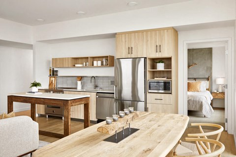 a kitchen and dining room with a table and a refrigerator