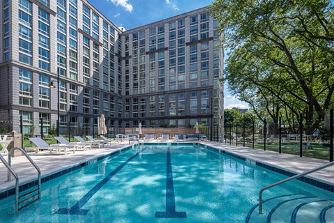 a swimming pool in front of a tall building