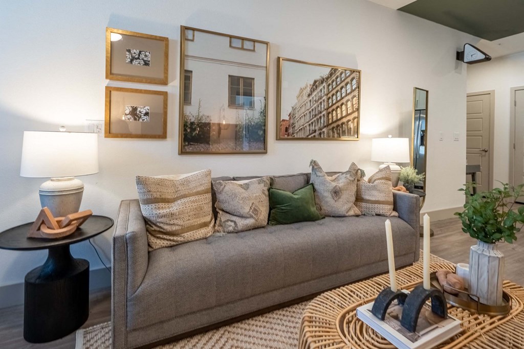 a living room with a couch and pictures on the wall