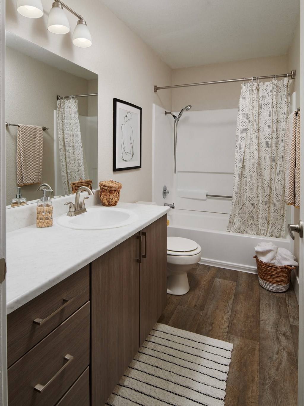 a bathroom with a toilet sink and bathtub in a 555 waverly unit