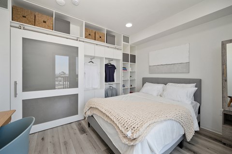 a bedroom with a bed and a closet