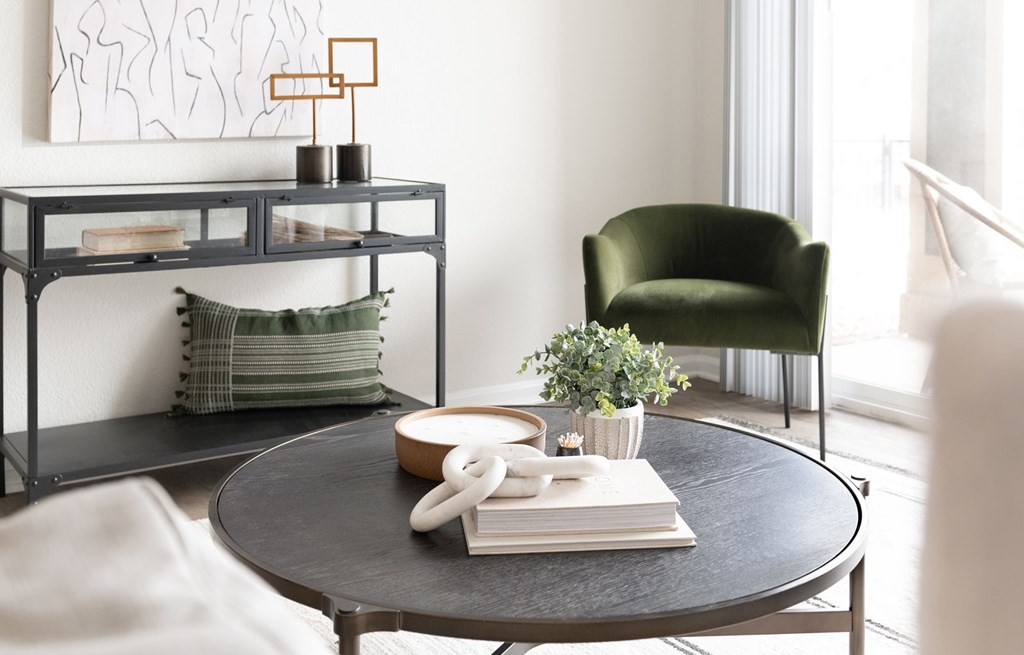 A black round table with a white phone and a book on it.