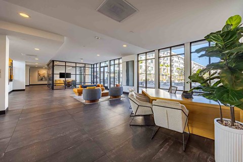 A modern living room with a long wooden table and chairs.