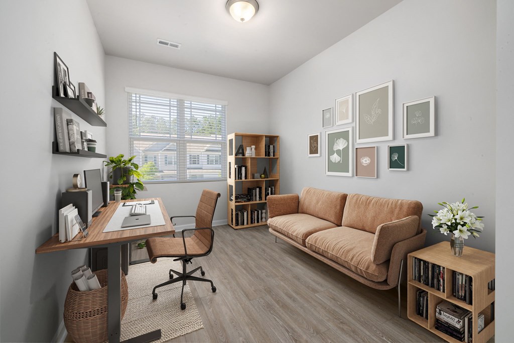 a living room with a couch and a desk