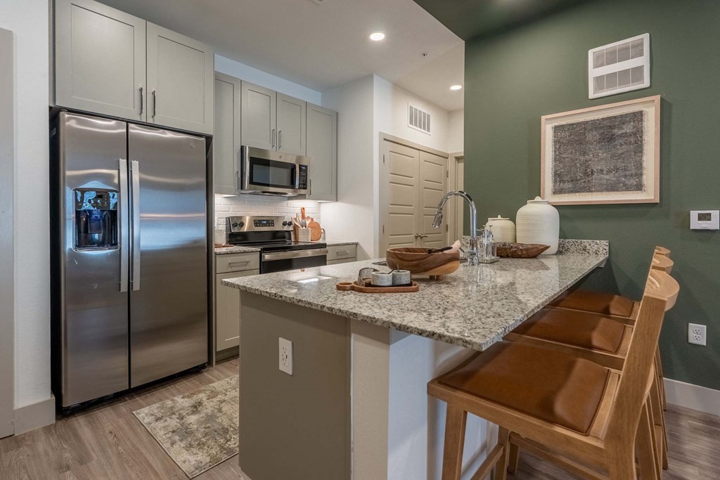 a kitchen with stainless steel appliances and a granite counter top