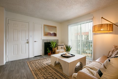 A living room with a white couch and a coffee table.