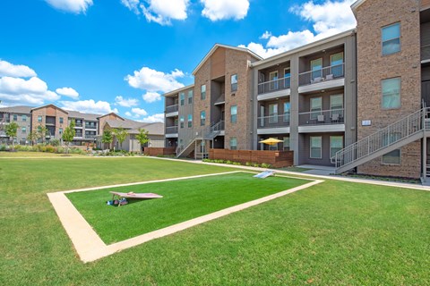 a courtyard with a small plane in front of an apartment building