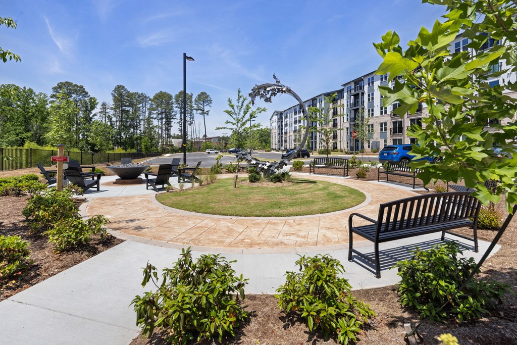 A park with a bench and a walking path.