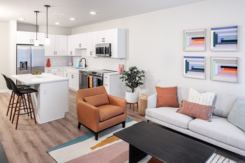 A modern kitchen with a dining table and chairs.