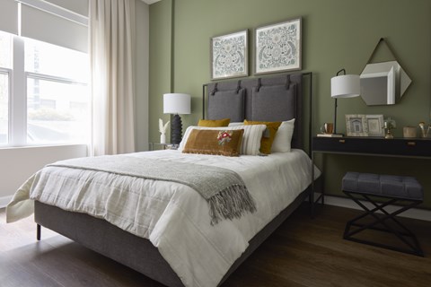 A bedroom with a large bed and a window.