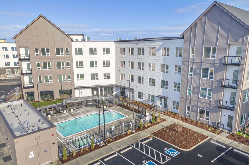 a rendering of an apartment building with a swimming pool