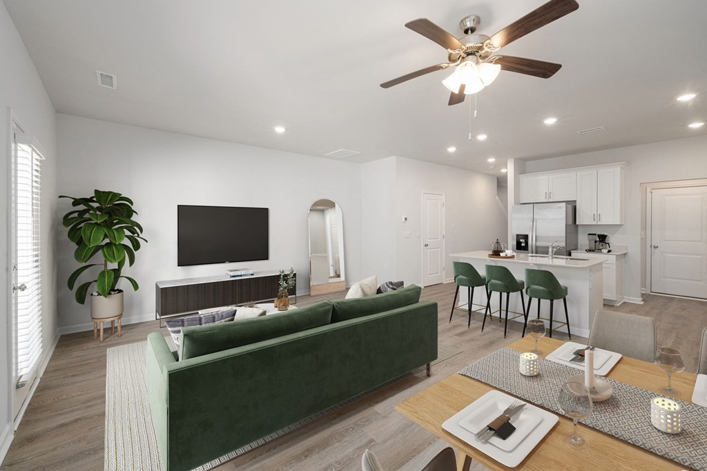 a living room with a couch and a table with chairs