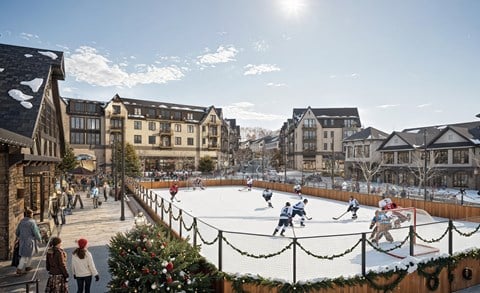 People playing hockey on an outdoor rink.