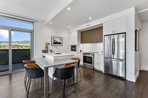 a kitchen with a refrigerator freezer next to a stove top oven