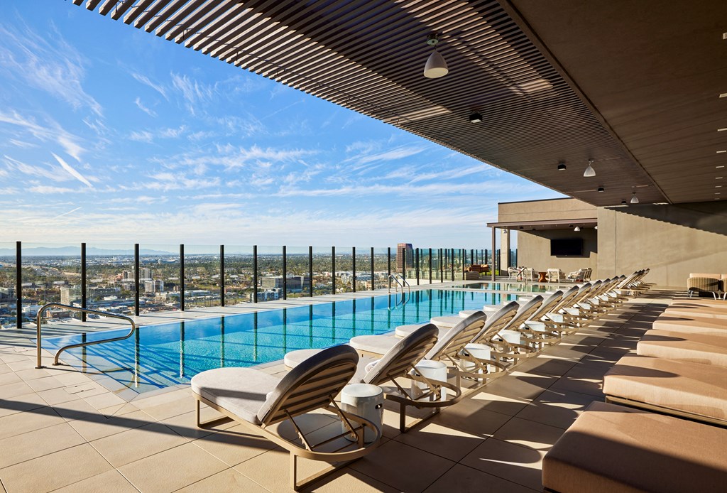 Outdoor pool with lounge seating, shade cover, ceiling lighting