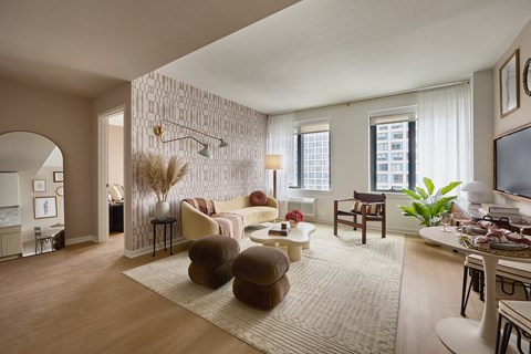 A living room with a white sofa and a brown armchair.