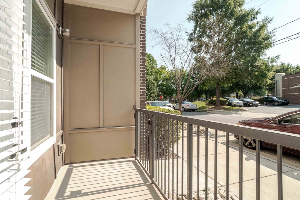 a balcony with a view of a parking lot