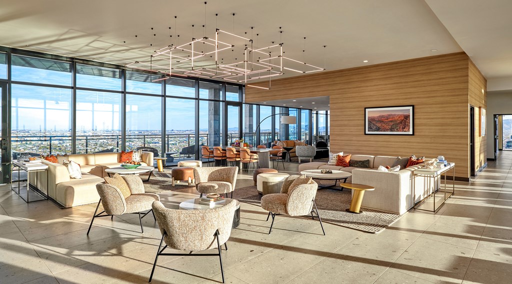 Indoor lounge space with lounge seating, ceiling lighting, large windows