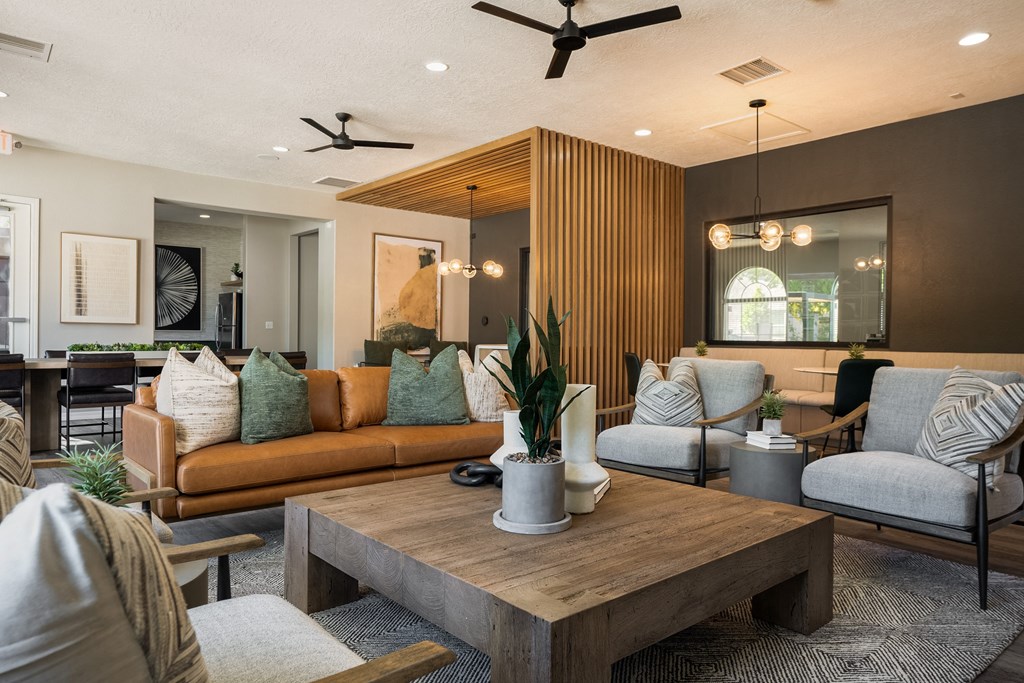 a living room with couches and chairs and a table