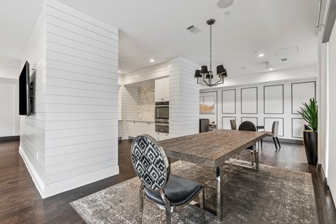 A modern dining room with a wooden table and chairs.