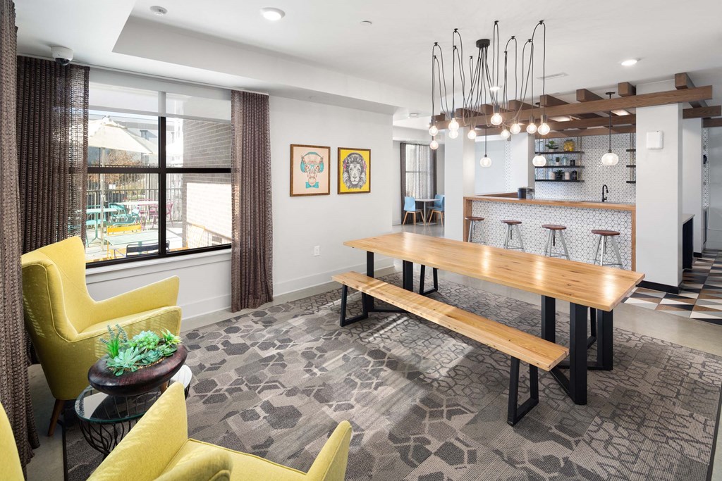 a dining room with a wooden table and yellow chairs
