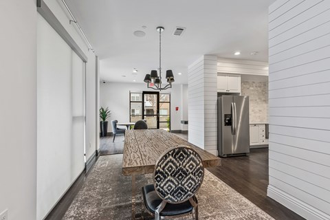 A modern dining room with a wooden table and patterned chairs.