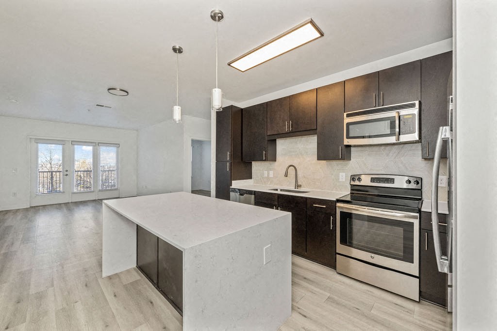 a kitchen with a white island and black cabinets