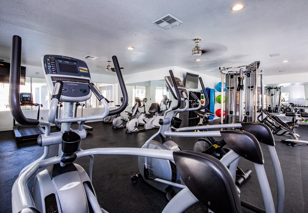 A gym with treadmills and other exercise equipment.