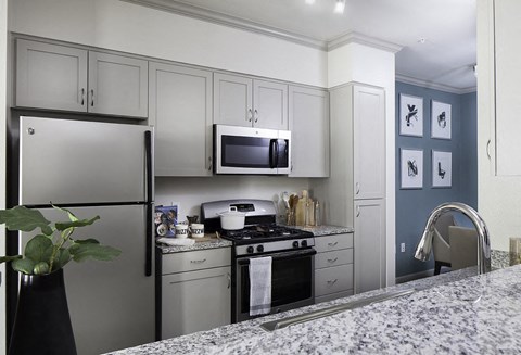 a kitchen with stainless steel appliances and white cabinets